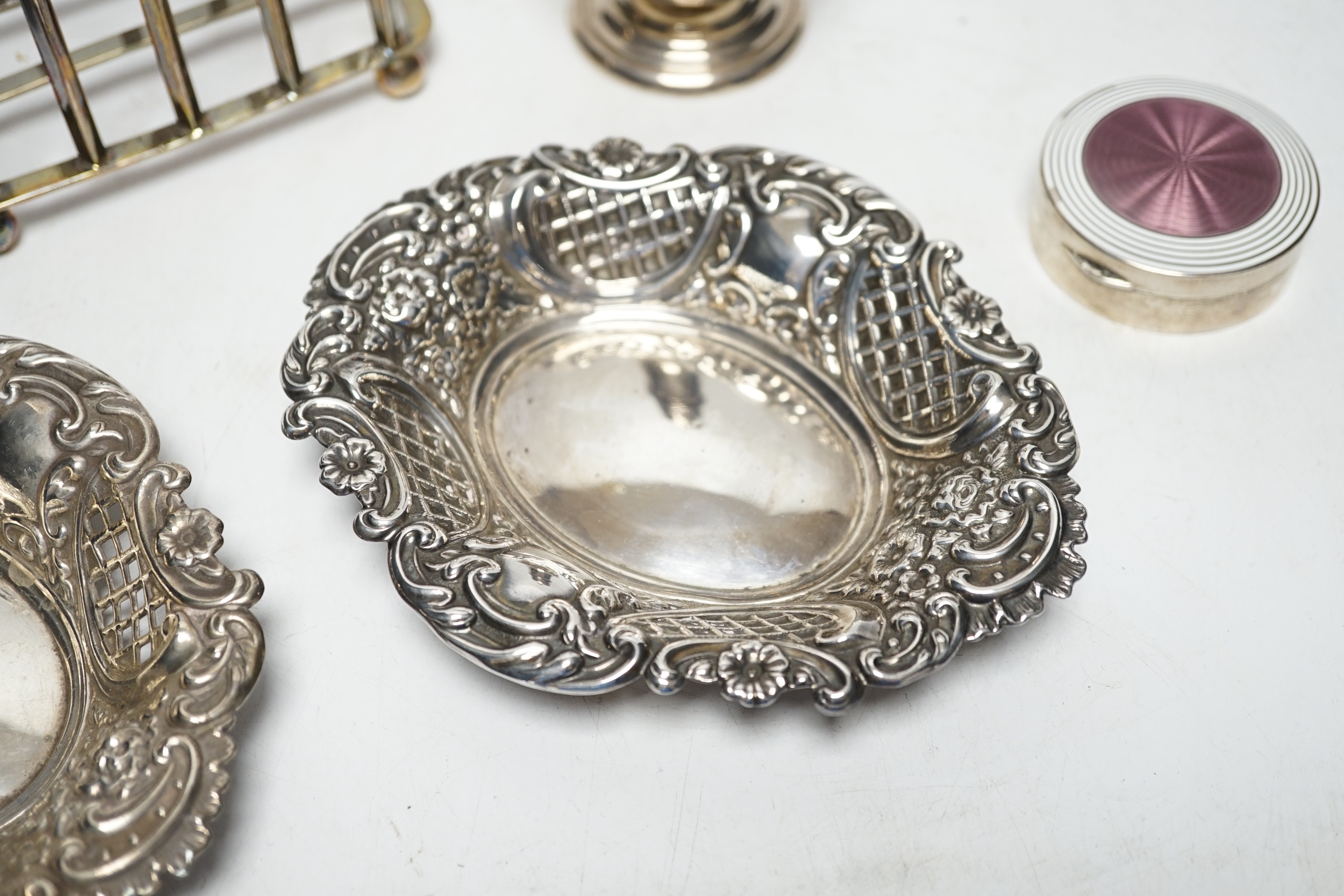 A 1930's silver sugar caster, 16.2cm, a silver five bar toastrack, two silver bonbon dishes and an early 20th century German 900 standard and two colour enamel circular pill box and cover, by Louis Kuppenheim (enamel a.f